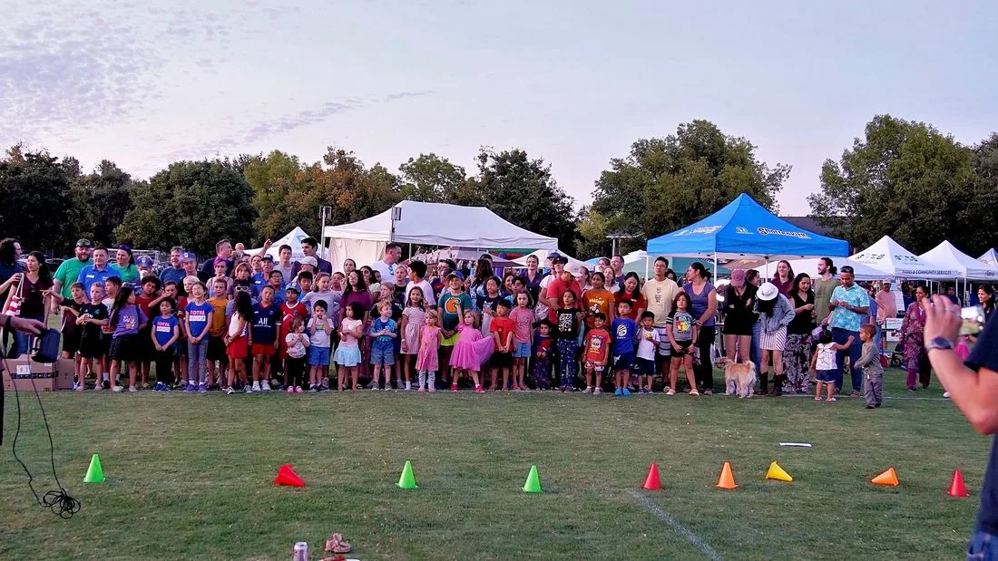 A large crowd of neighbors and businesses filling Community Park at Celebrate Davis