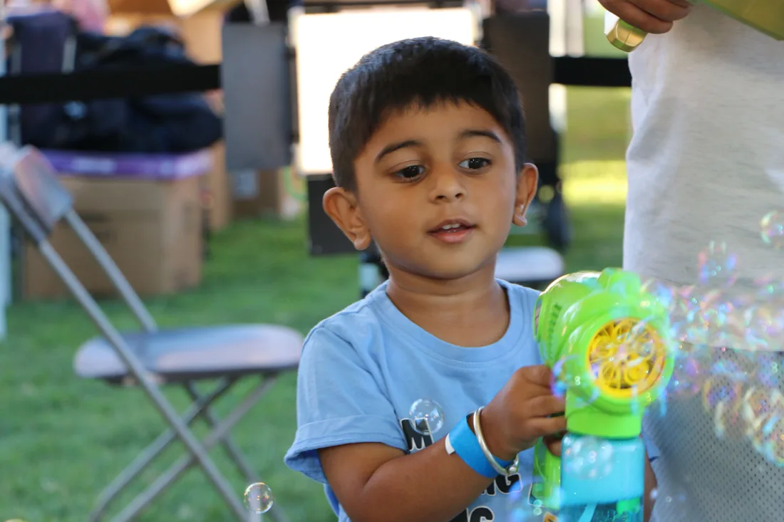 A young boy playing with a bubble gun at Family Fun Fest